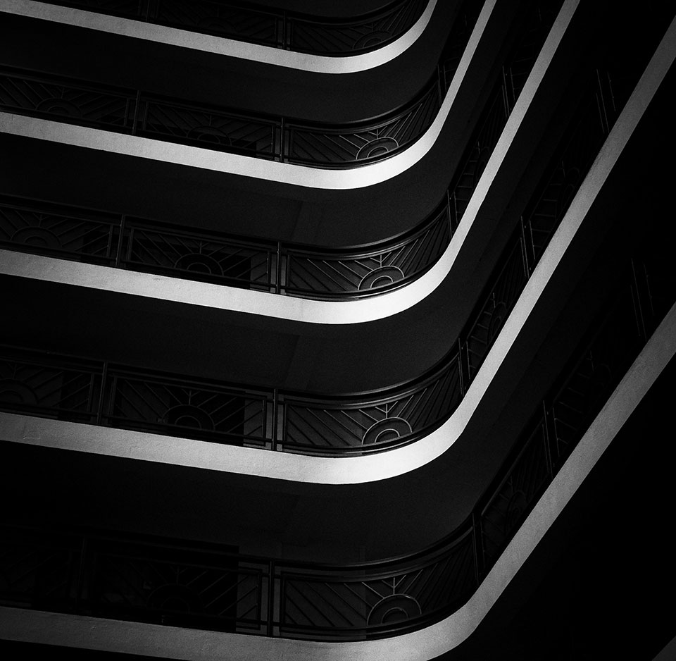 Black and white photo of exterior balconies in an art deco style.