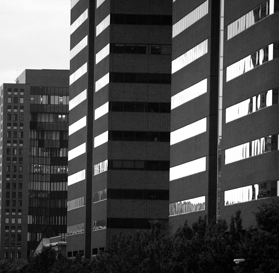 A row of skyscraper apartment buildings with large glass windows.