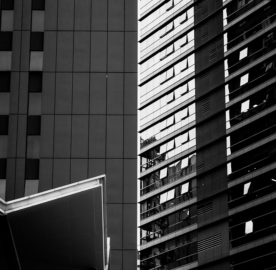 The exterior of a residential building made of mixed material using glass, brick and contrete.