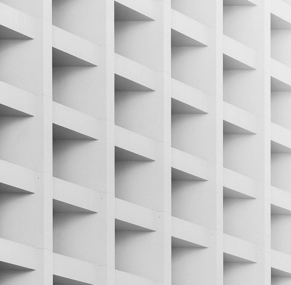 The exterior facade of a building whose supports create a checkered pattern.