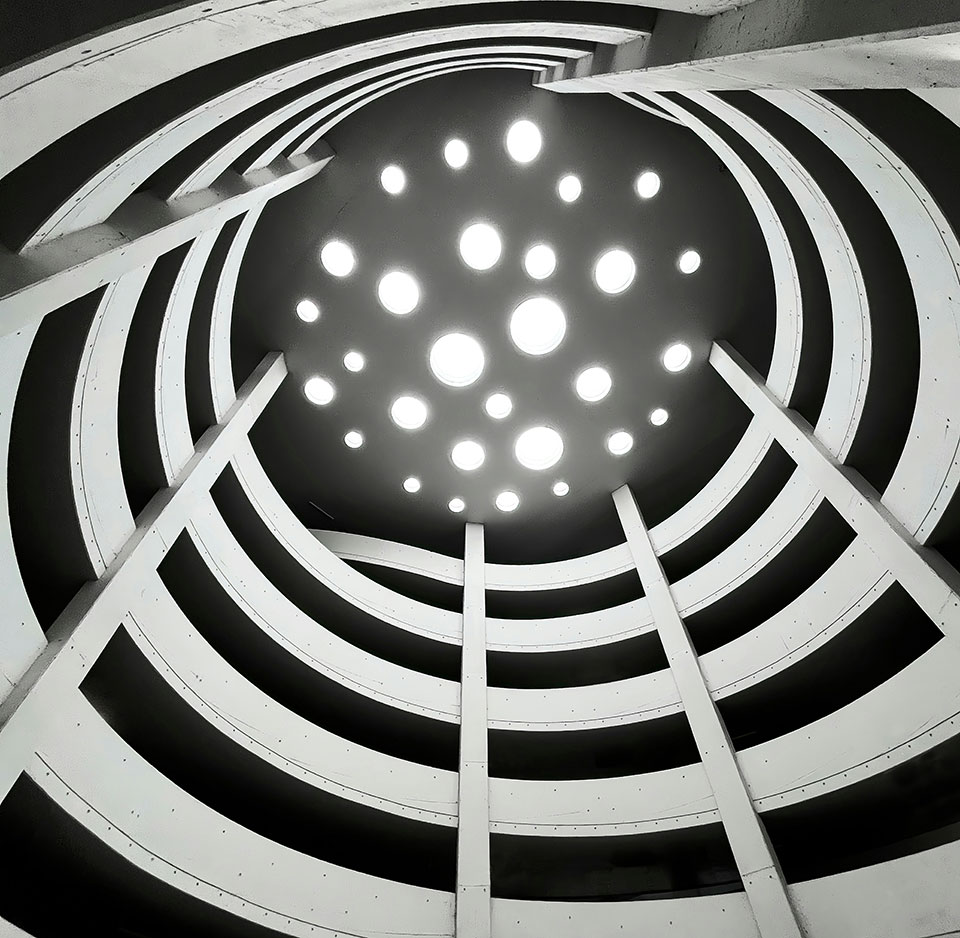 A view of an interior atrium and the spiral walkway that leads to the top floor.